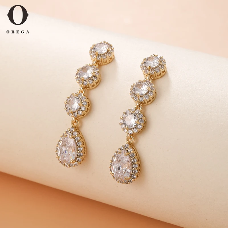 

Obega Female White Crystal Water Drop Stone Dangle Earrings Gold Color Zircon Long Drop Earrings For Women Wedding Royal
