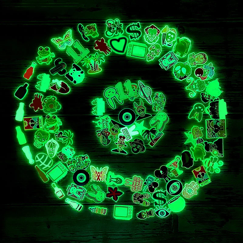 Glow-in-the-dark shoe charms in random mixed designs including horror characters, animals, peace signs, ghosts, and fun icons for Crocs