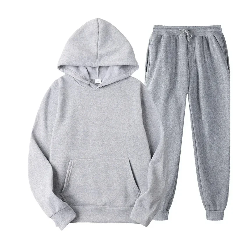 Man wearing solid color hoodie and jogger pants set in a cozy autumn streetwear setting L gray