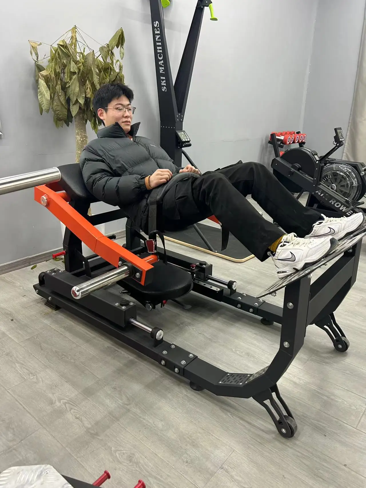 A man working out with a hip thrust machine sold by 100 Spartans