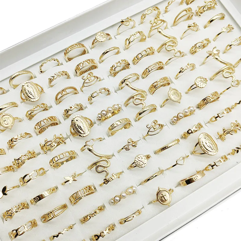 Assortment of gold colored thin band rings with pearl accents