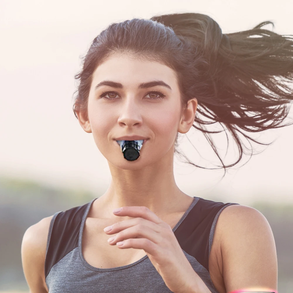 Person using a Portable Breathing Fitness Exerciser outdoors, demonstrating how to enhance lung capacity with adjustable settings.