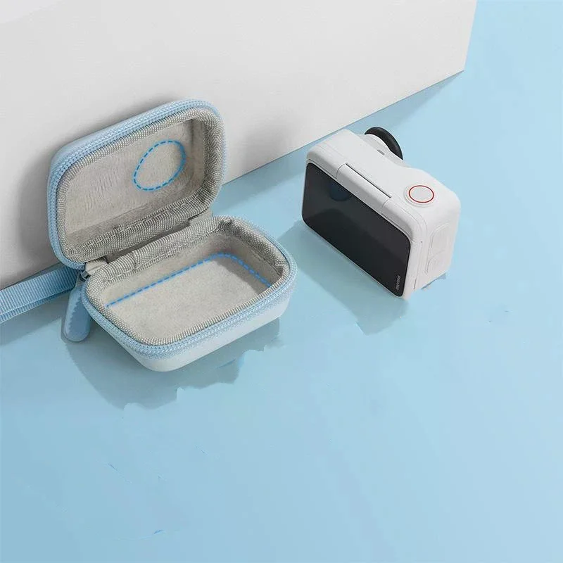 Sac de transport résistant aux chocs pour Insta360 GO, posé à côté de la caméra pour illustrer la taille compacte.