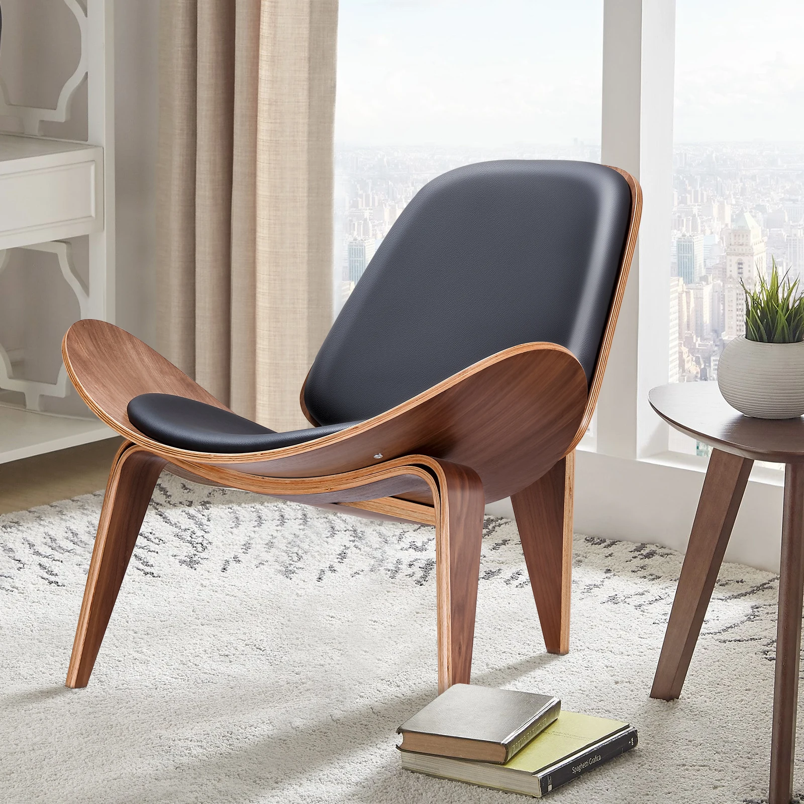 A Nordic three-legged chair with black leather upholstery and a view of the city.