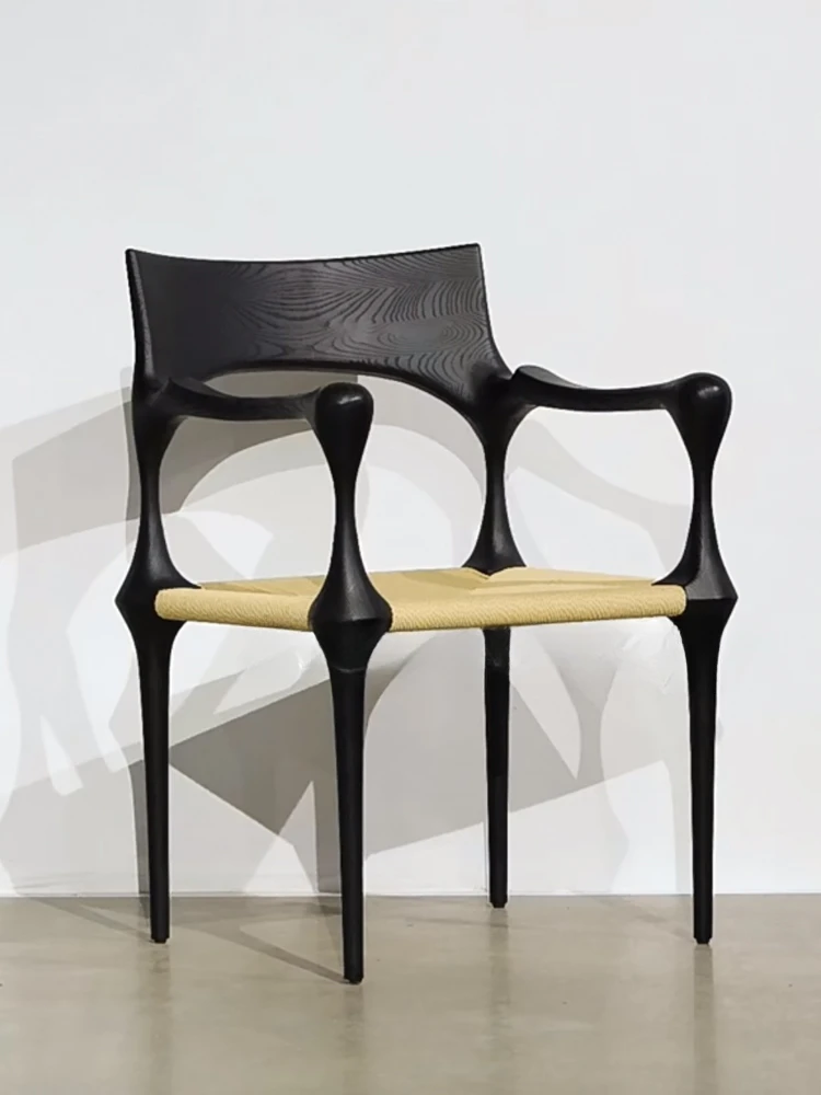 

The vintage solid wood vintage dining chair has a high back, an artistic creative chair, and a rattan black dining chair