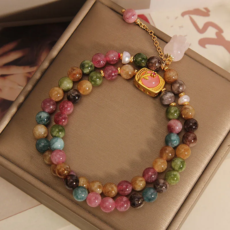 Light pink and green jade stones in beaded bracelet