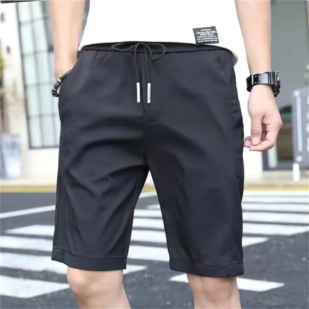 

High Quality Polyester Ice Silk Shorts Men New Korean Version Of Loose Elastic Splicing Beach Five Minute Medium Pants