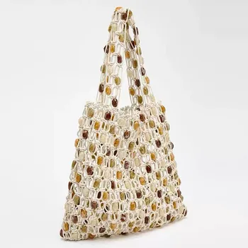 Nuova borsa estiva casual con perline da donna, borsa intrecciata di fascia alta di nicchia alla moda con perline di legno scavate a reticolo, borsa da spiaggia