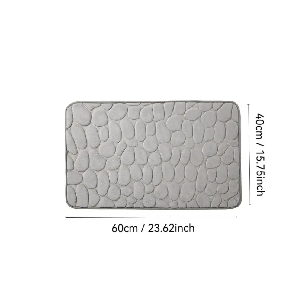 Cobblestone-textured gray bath mat with non-slip backing for bathroom floor.