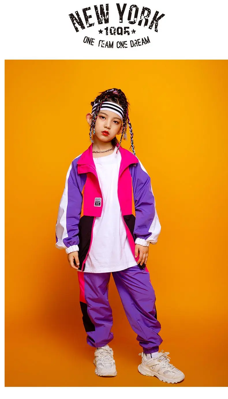 Child wearing patchwork jacket and joggers in hip hop street dance poseny 12457