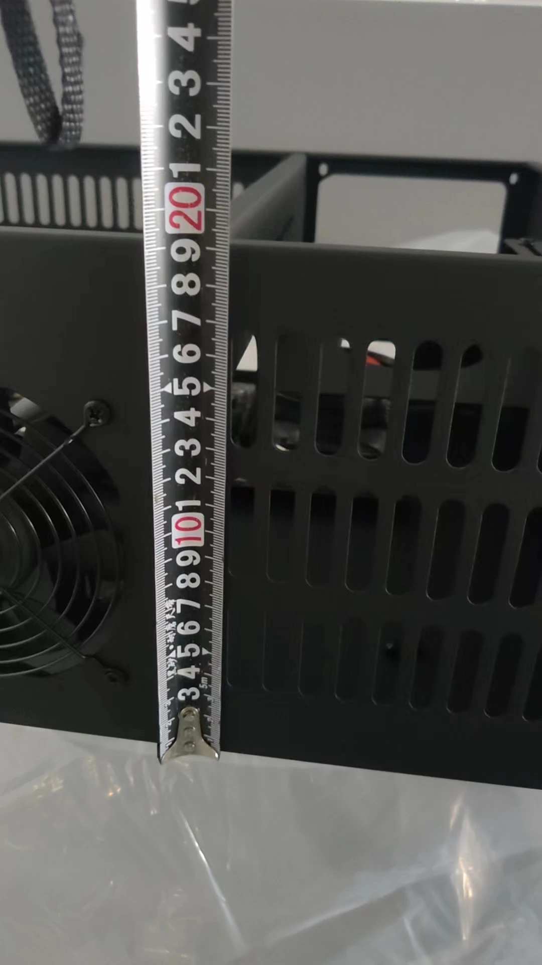 A set of eight PCI card slots in a miner's chassis. The mainboard model is ETH B85 V2.11. There is one fan on the mainboard