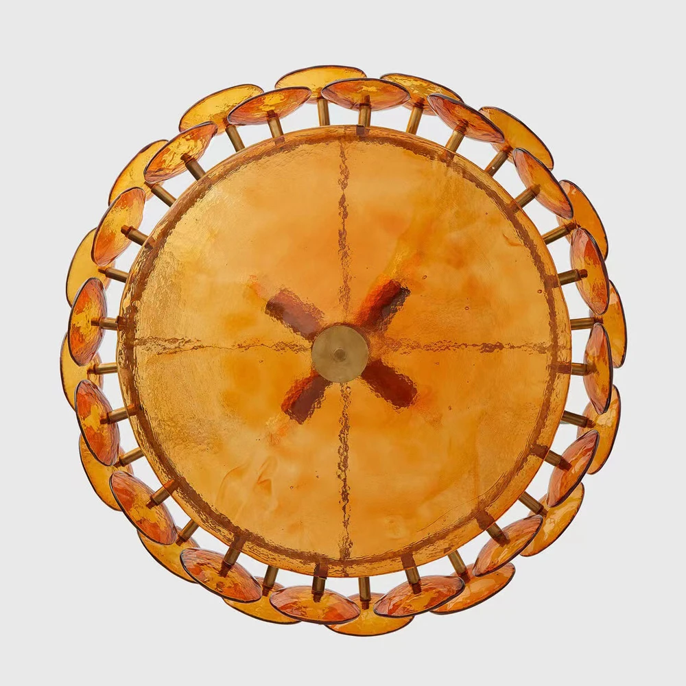 The Italian Retro Pendant Light features a round amber Murano glass design with a braided rim and central hub, elegantly displayed from below against a plain background to highlight classic Italian craftsmanship.