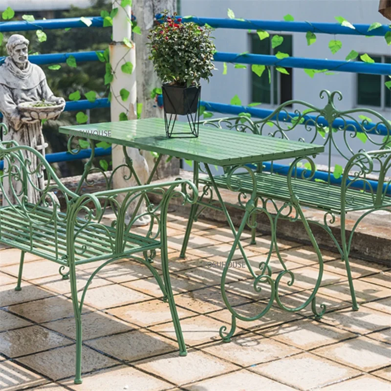 green wrought iron table and chairs