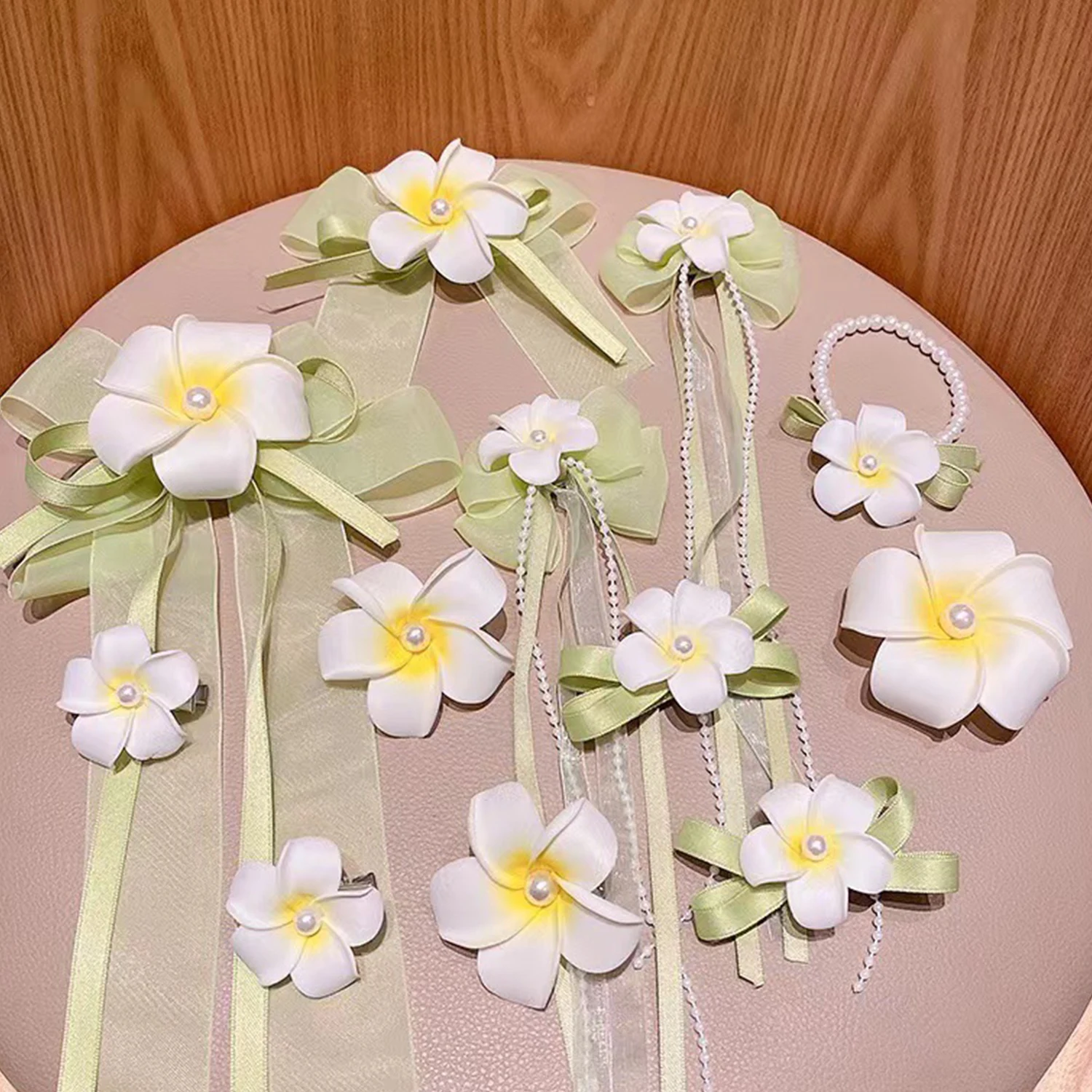 

1/2Pcs Fashion Lovely Lady Hawaii Flower Bow Tassel Hair Clip Seaside Wedding Bridal Hair Jewelry Simulation Frangipani Hairpins