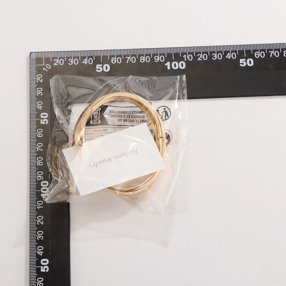 Gold-tone cuff bracelet with pearl ends for women – wide statement bangle with modern fashion appeal.