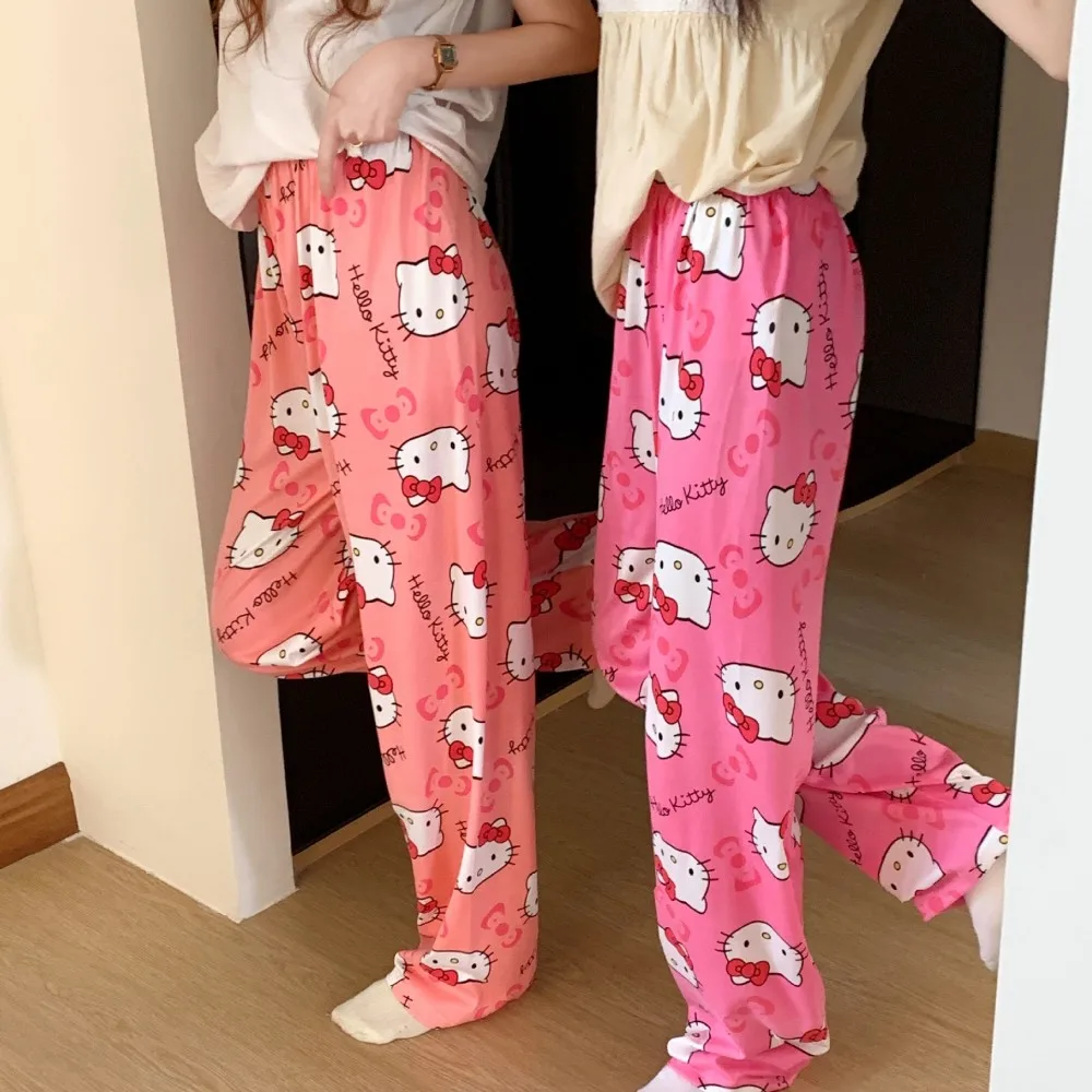 A pair of loose-fitting Hello Kitty pajama pants with a charming cartoon print pink red 2