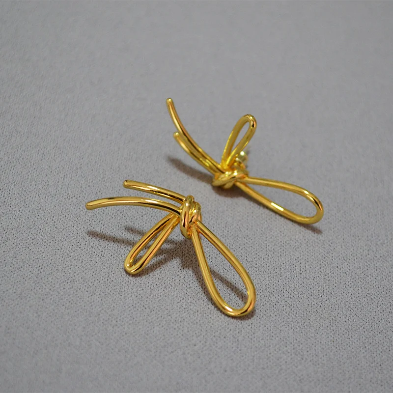 

South Korea's fashionable and trendy design sense, line bowknot design, simple temperament, 925 silver needle earrings,