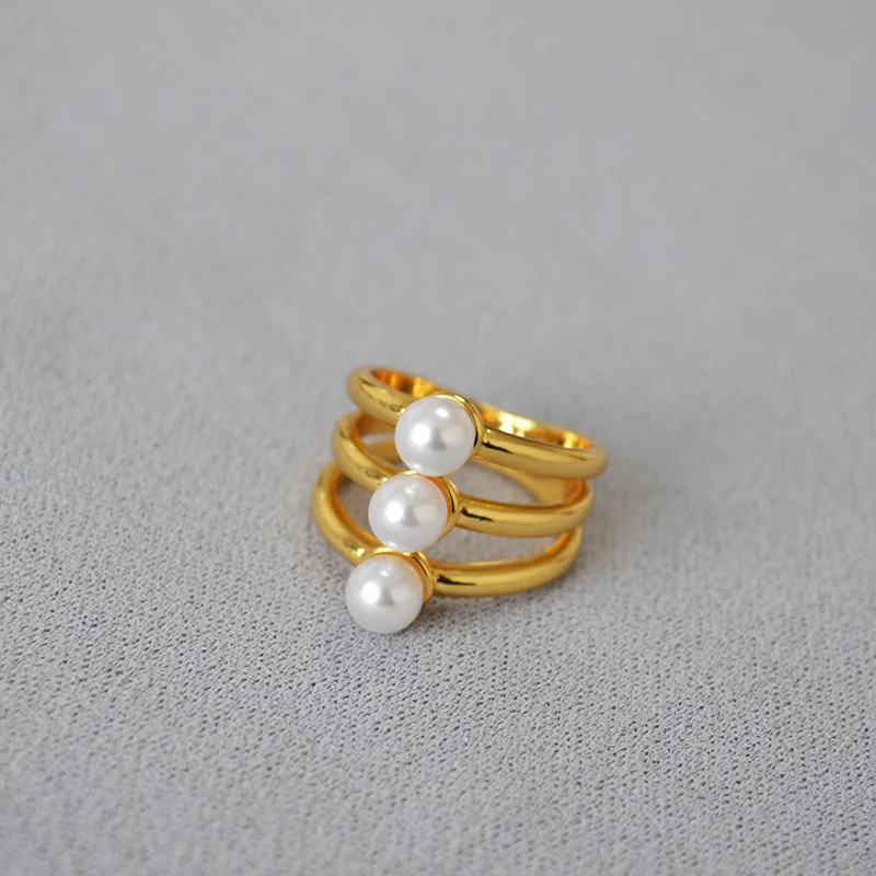 

Japanese and Korean niche designs with multi-layer lines, brass plated gold inlaid artificial pearls, a minimalist ring