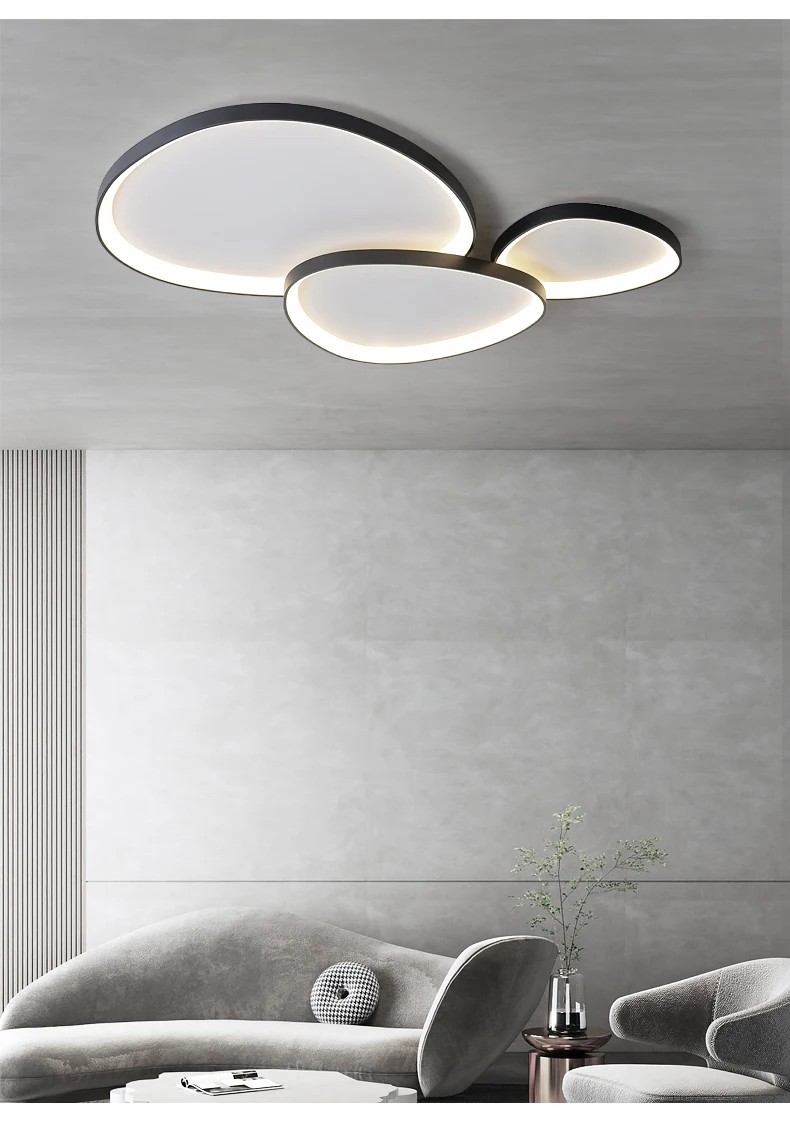 Modern living room with a Nordic Minimalist Ceiling Light featuring dimmable brightness and color temperature control, paired with a gray sofa, small round table, and sleek decor.