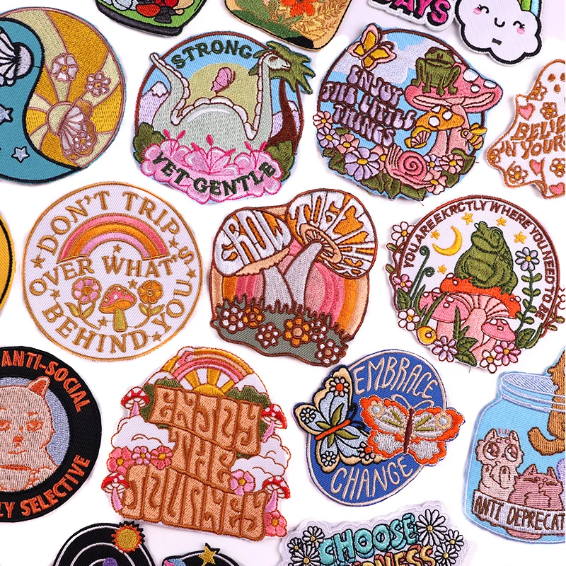 Colorful embroidered patch with “Don’t Trip Over What’s Behind You” text, mushrooms, and rainbow in retro lettering