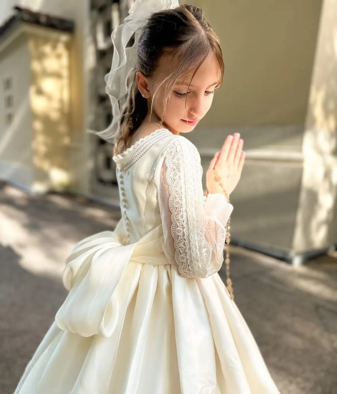 FATAPAESE First Communion Dress Made with Satin Fabric Long Sleeves with Vintage-like Laces Bow and Covered Buttons for Closure