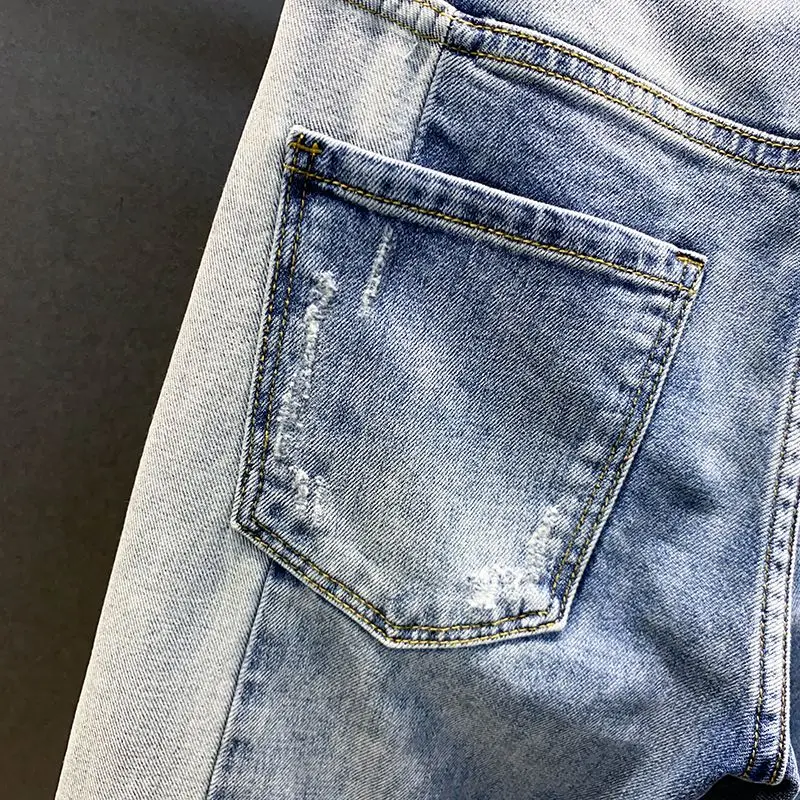 Autumn style high street color contrast patchwork ripped jeans men's trendy beggar slim fit small foot long pants Korean version