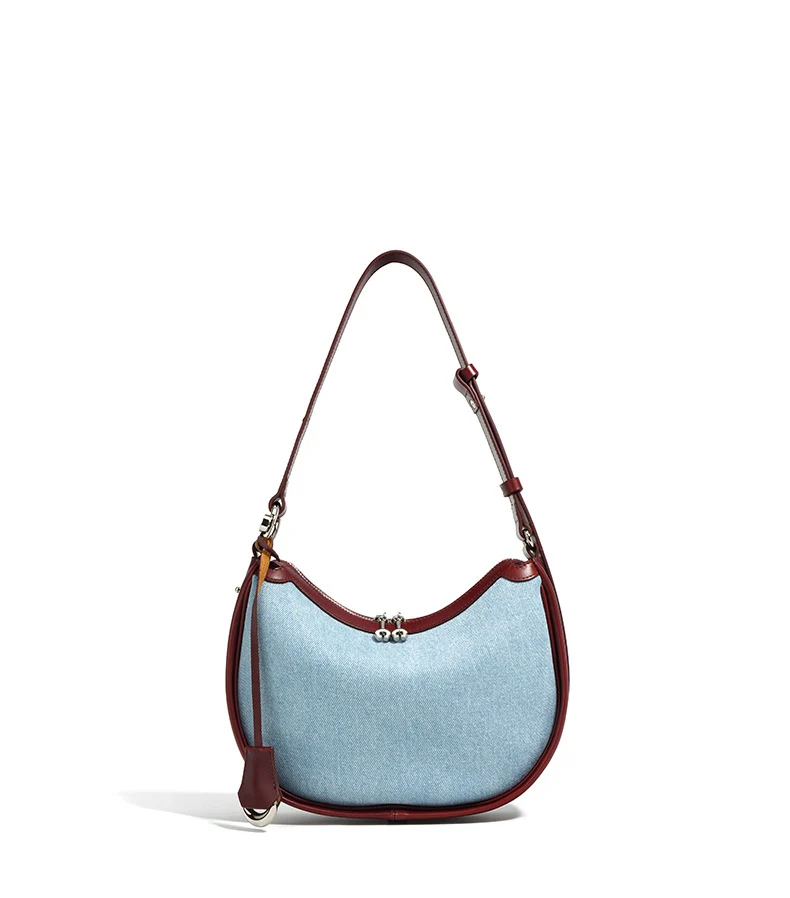 Half moon shoulder bag made of denim with genuine leather trim – casual and stylish design for daily use.