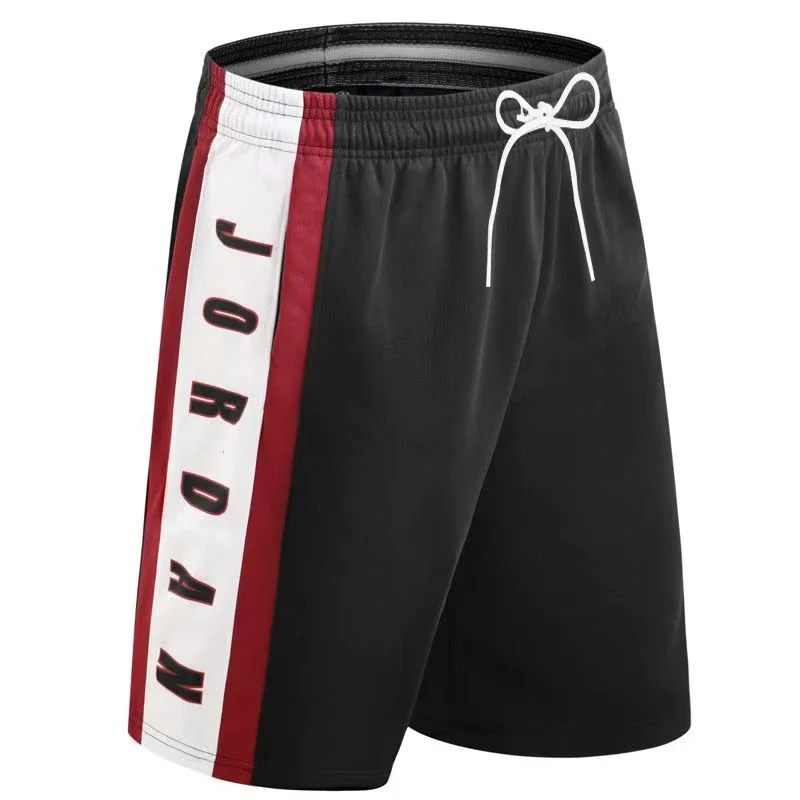Unisex MOTO beach basketball shorts displayed on model with surfboard and racing helmet, highlighting breathable fabric and sporty design black