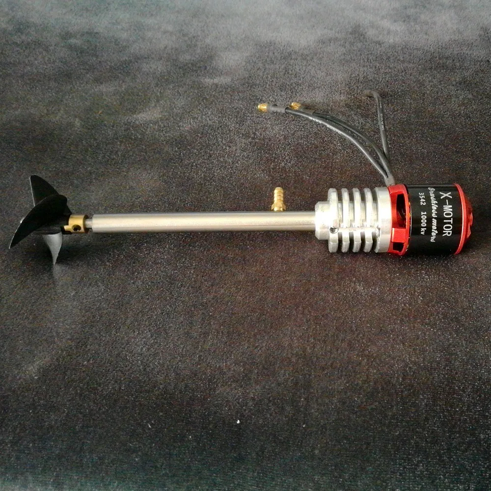 Moteur RC 1000KV posé sur une surface noire, mettant en avant son boîtier métallique et son axe central.
