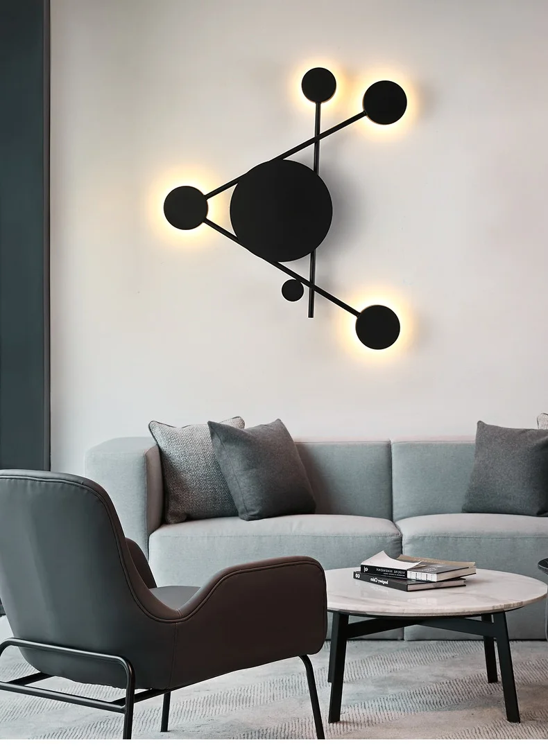 A minimalist living room with a matte black circle wall sconce.