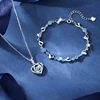 Silver necklace and bracelet set with blue heart-shaped crystal