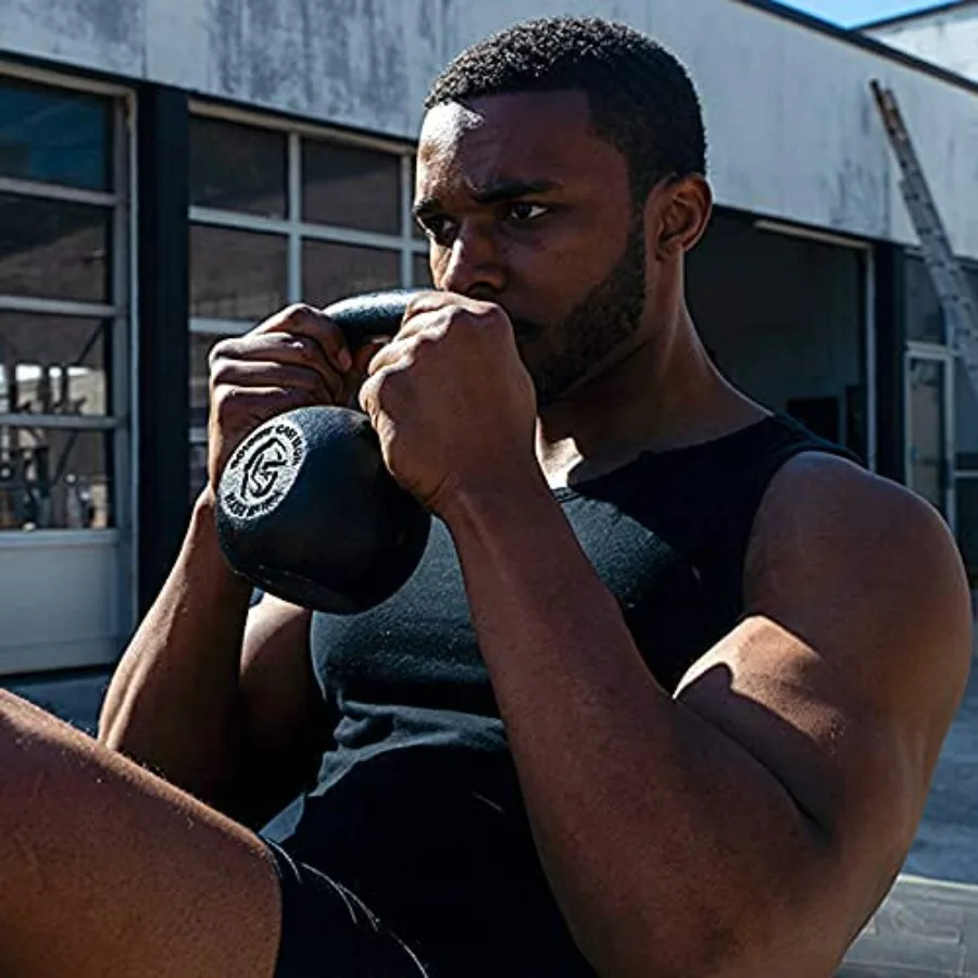 Heavyduty cast iron kettlebell weighing 12kg 26lb ideal for strength training functional fitness and home gym workouts with dur