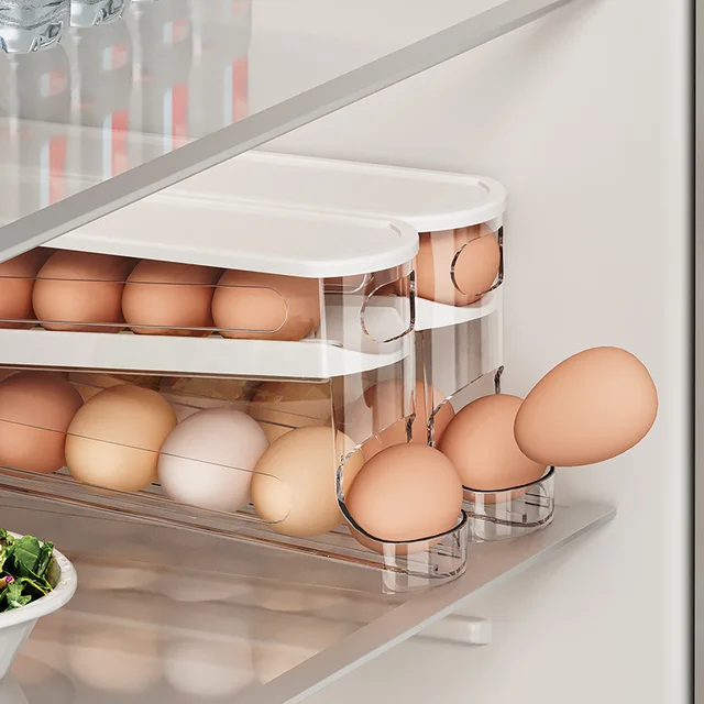 A white, 2-tier automatic rolling fridge egg holder inside a refrigerator, neatly storing eggs.