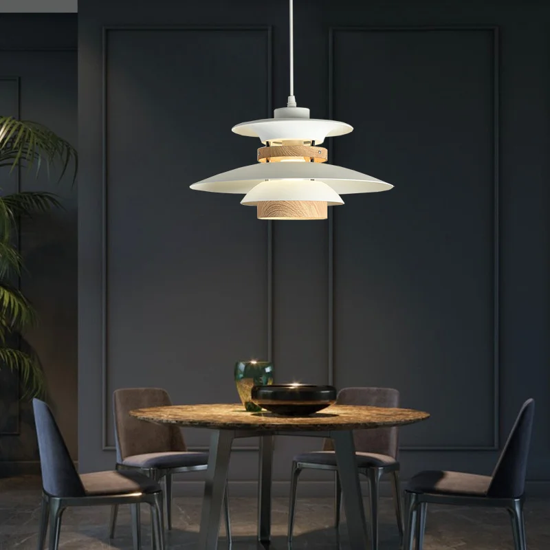 A modern dining room with a Scandinavian touch, featuring a black table and chairs contrasted with natural wood accents.