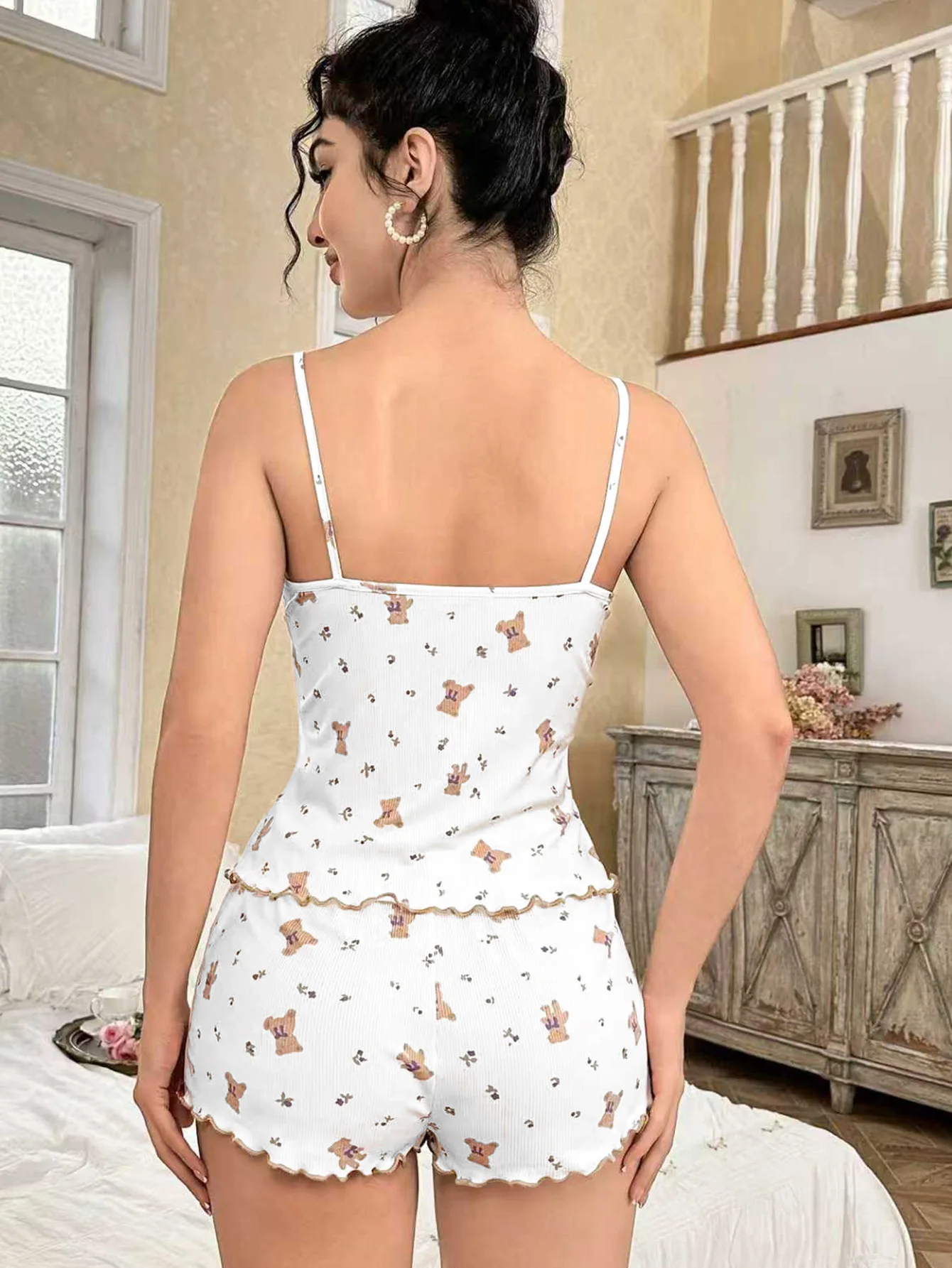 Back view of a two-piece sleepwear outfit with thin straps and printed shorts