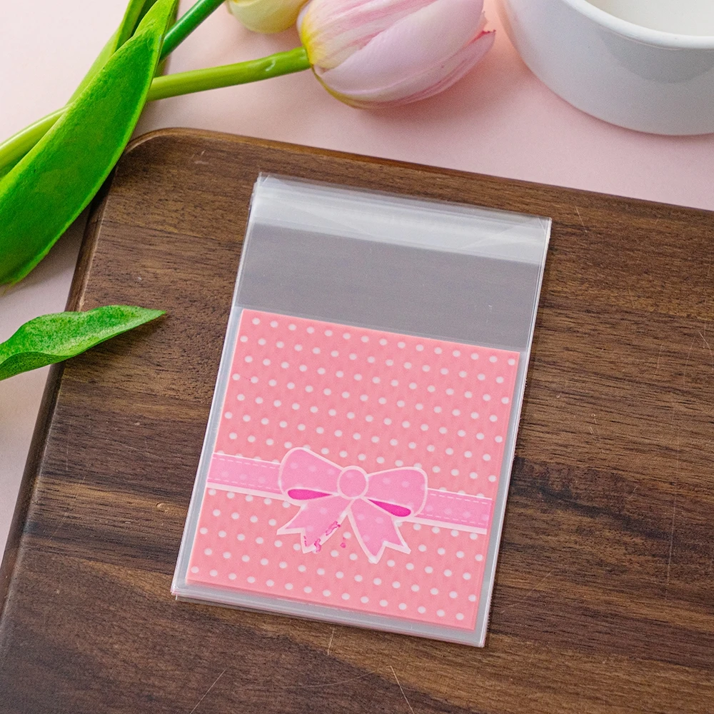 100 stücke 7x7cm rosa quadratische Geschenk verpackung opp selbst dichtende Tasche schöne Schleife Druck opp selbst versiegelte Tasche, Geschenk Süßigkeiten Verpackung Taschen – Detail 6