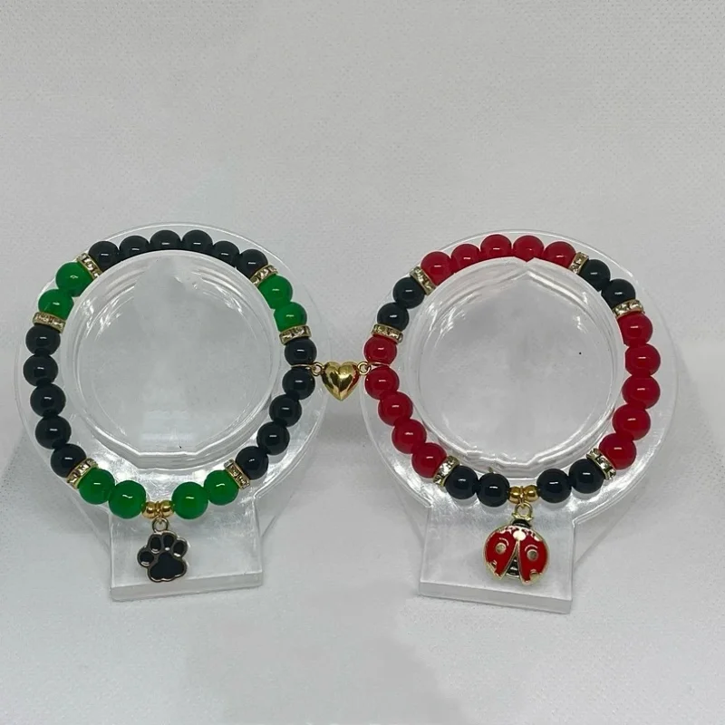 Handmade red and green bead bracelets with ladybug and cat