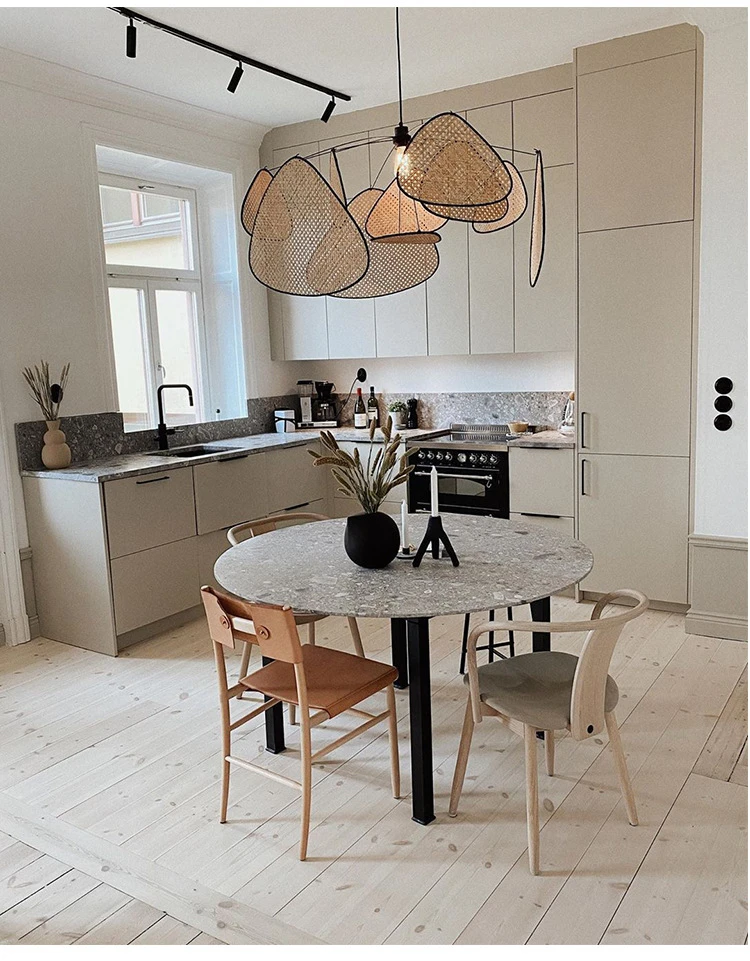 An organic meets modern kitchen with a wooden table and chairs.