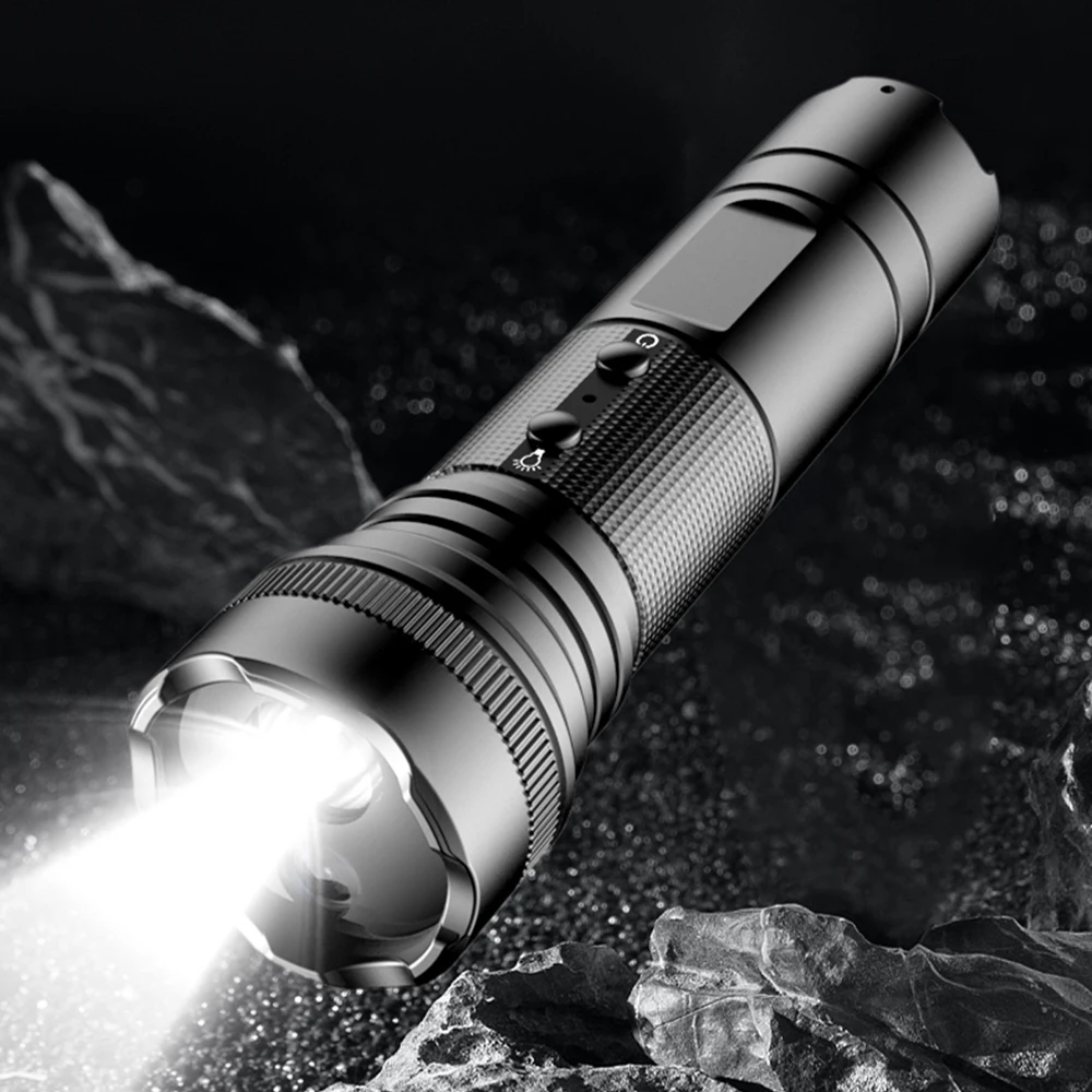 A black Outdoor Flashlight SpyCam rests on a dark, textured surface surrounded by rocks, emitting a bright beam of light.