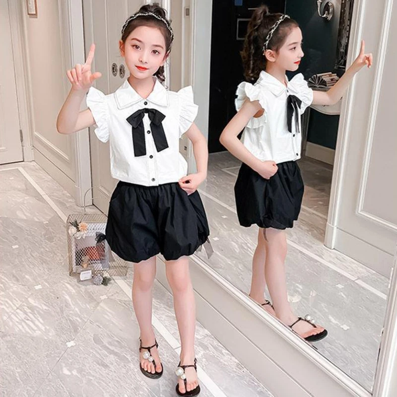Adorable toddler girl 2-piece outfit featuring a bow top with flying sleeves and matching shorts, perfect for girls aged 0-4 years.