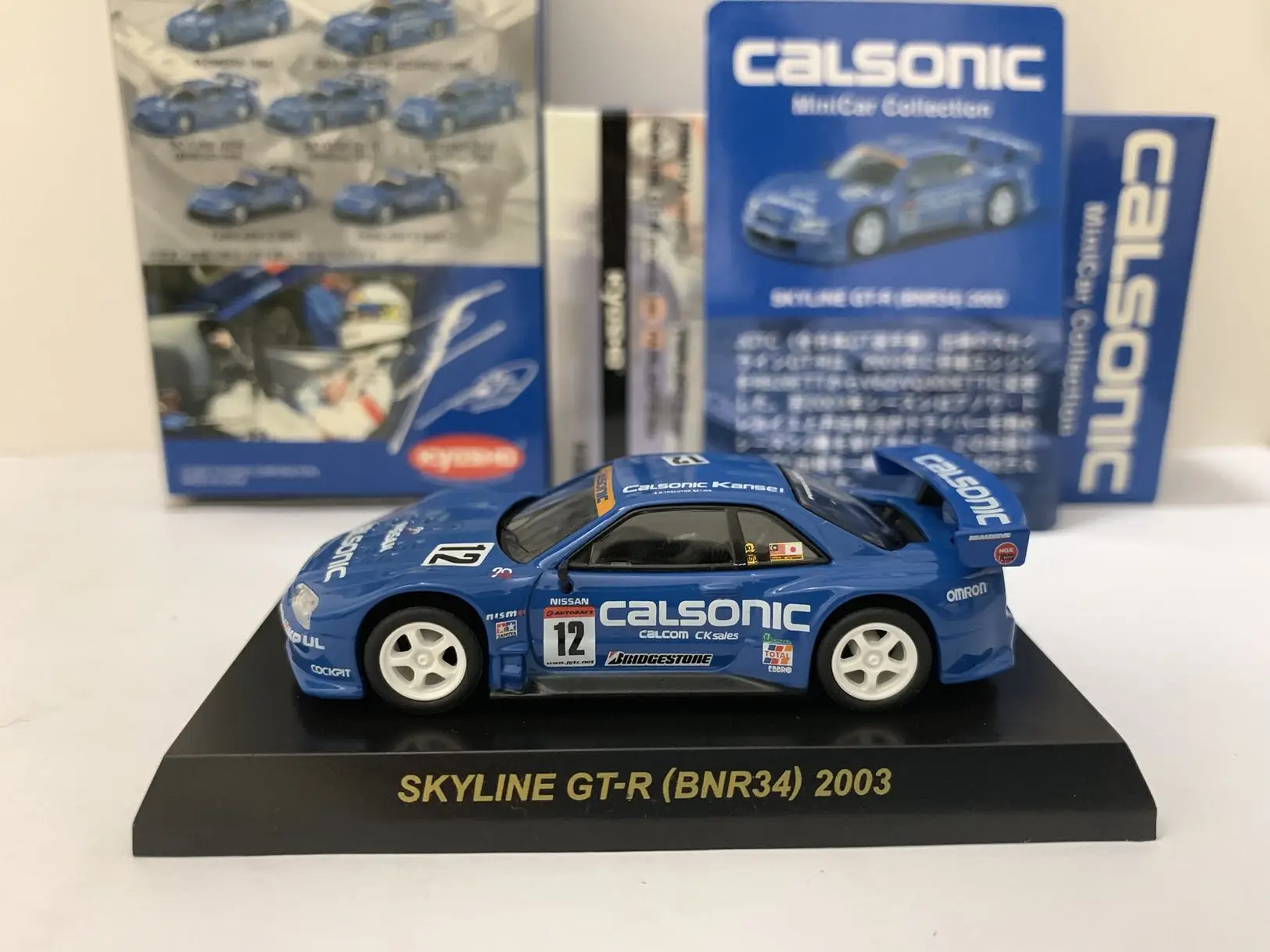 

1:64 KYOSHO Nissan skyline GT-R BNR34 Calsonic camouflage 2003 #12 Diecast Collection Simulation Alloy Car Model Children Toys