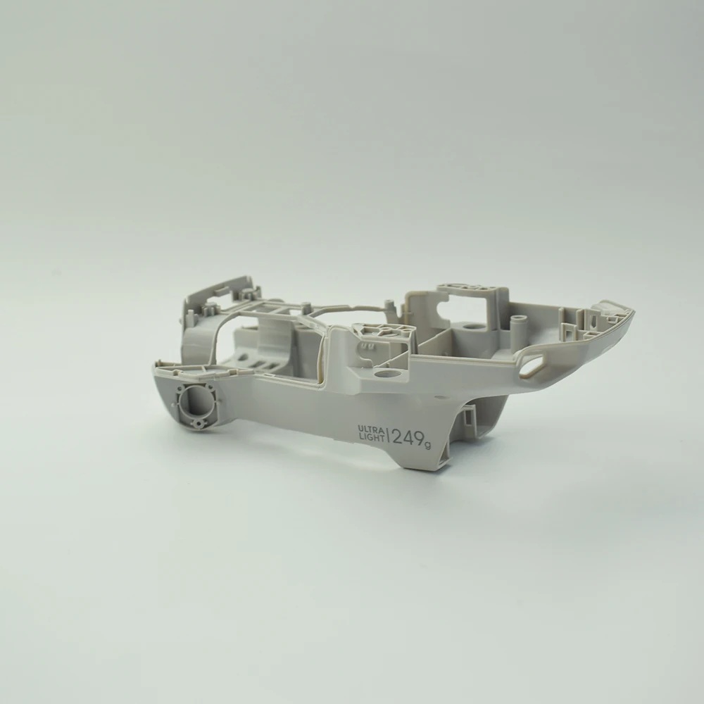 Détail du cadre coque centrale pour réparation de DJI Mavic Mini 2, montrant les fixations et le logo DJI.