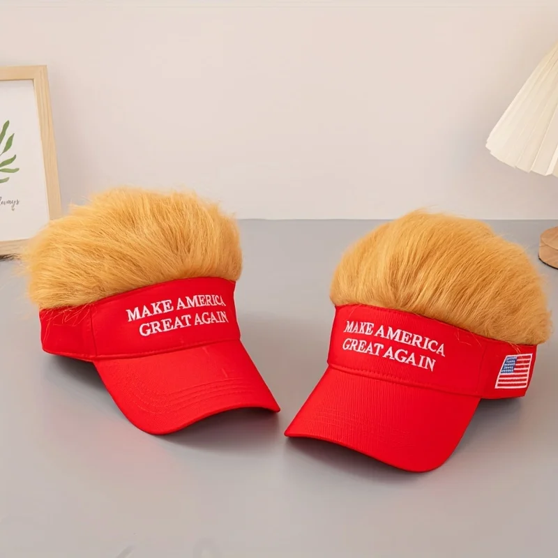 Two red Visor Cap - Make America Great Again hats with attached blonde faux hair sit on a gray surface—a fun, satirical cap that's sure to spark conversation and show your patriotic spirit at any event.