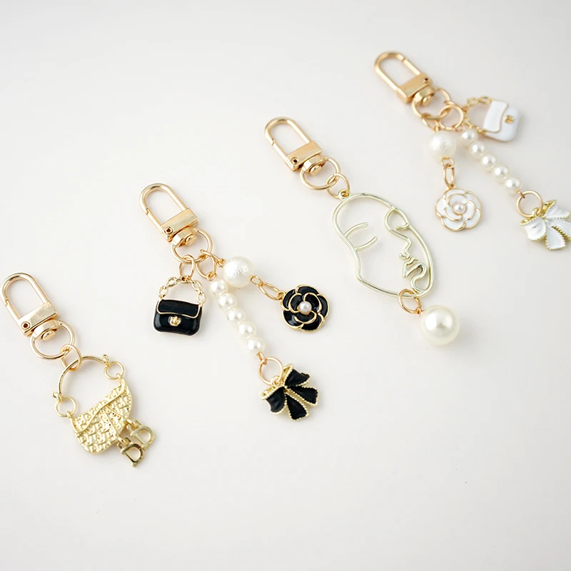 

High Quality Gold Metal Luxury Camilia Flower Bowknot Purse Pearl Keychain For Girl Women Key Chains Bag Pendent Charm X335