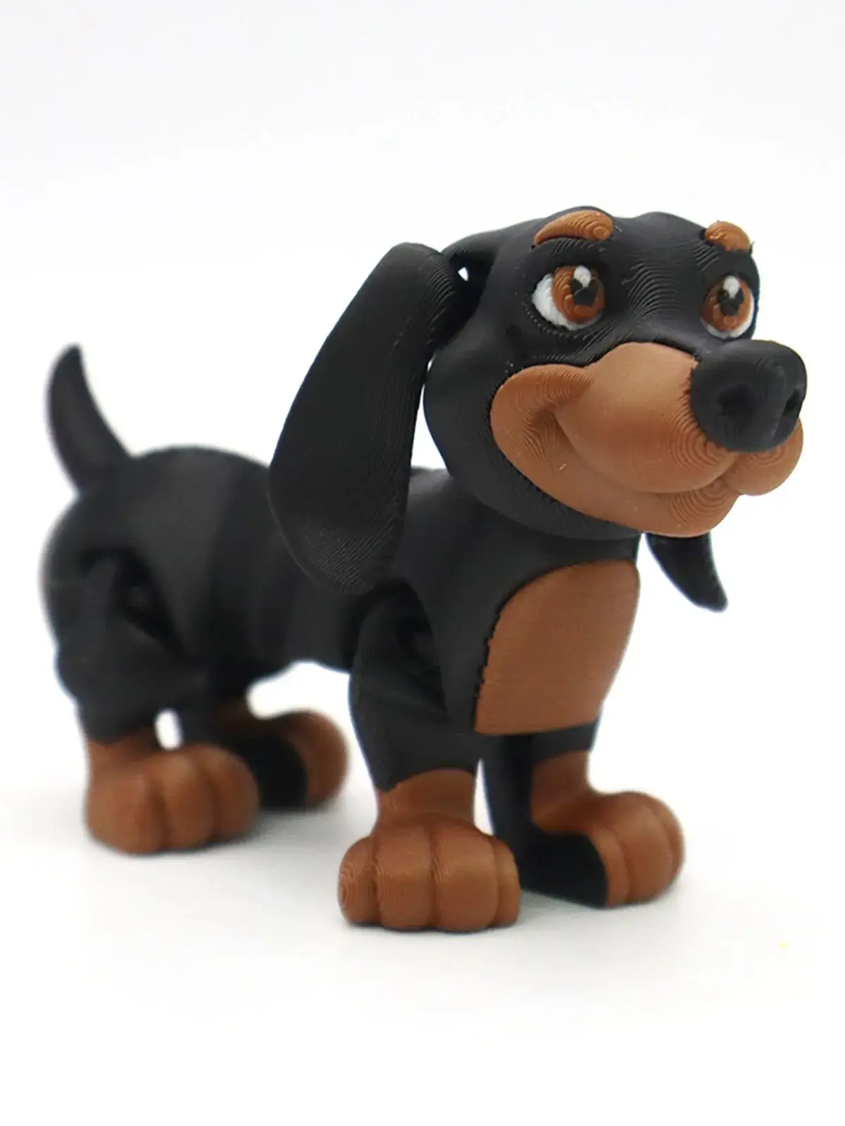 Miniature 3D black and tan Dachshund dog toy figurine showing 4-inch product dimensions for home shelf and office desk decor.