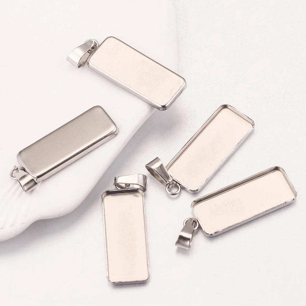 10 Stück 10 x 25 mm rechteckige Edelstahl-Cabochon-Basis-Charms, leere Anhänger-Fassungstabletts mit Bügeln für die DIY-Schmuckherstellung