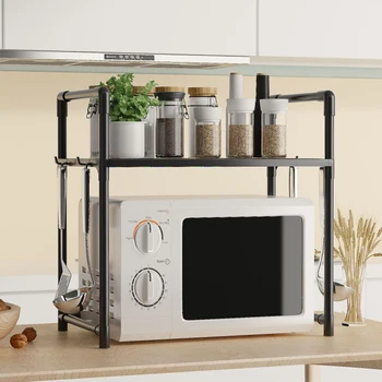 A sturdy, black 2-tier microwave shelf sitting on a kitchen counter, with a microwave underneath and spice jars on top.