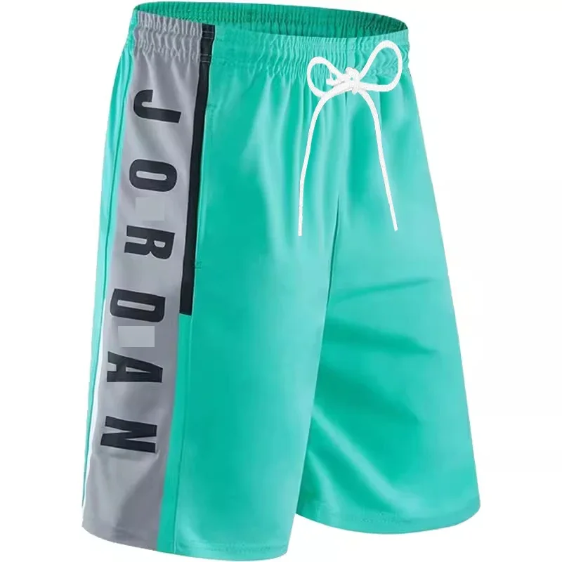 Unisex MOTO beach basketball shorts displayed on model with surfboard and racing helmet, highlighting breathable fabric and sporty design L green