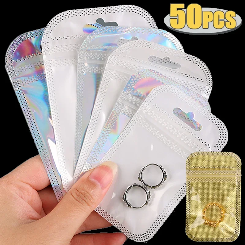 50pcs Thicken Resealable OPP 가방 레이저 무지개 빛깔의 가방 DIY 쥬얼리 만들기위한 교수형 구멍이있는 명확한 저장 가방 흰색 가방