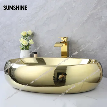 อ่างล้างหน้าแบบวางบนเคาน์เตอร์ทรงรี KEMAIDI Luxury ขนาด 23 นิ้ว สีทอง ทำจากเซรามิก พร้อมก๊อกน้ำแบบน้ำตกสีทอง 1